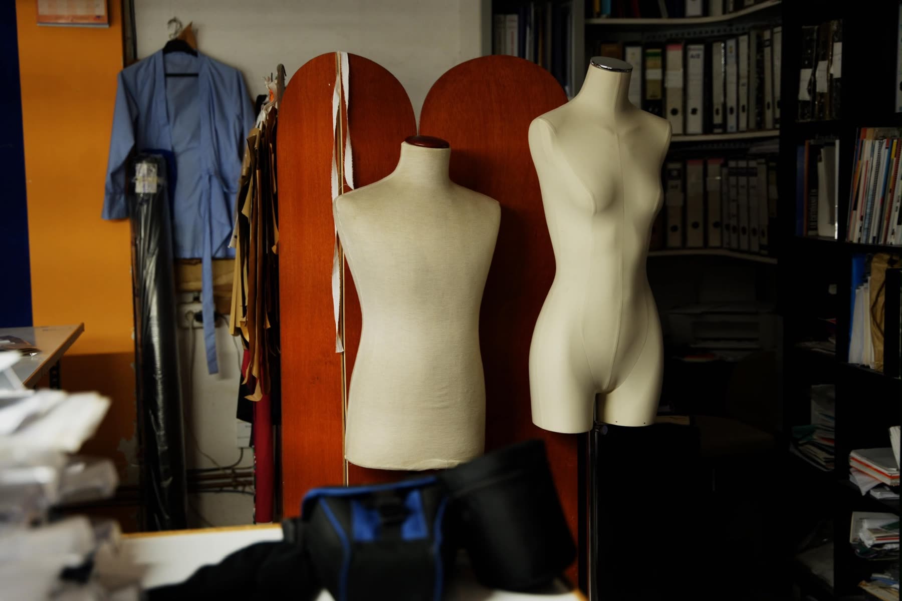 A rail of garments being prepared in the atelier