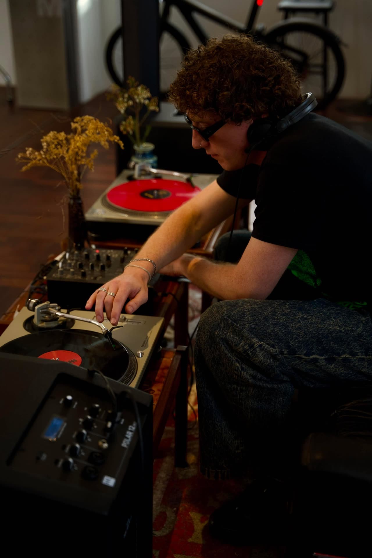 A creator at the turntables during a SIXSIXSS evening